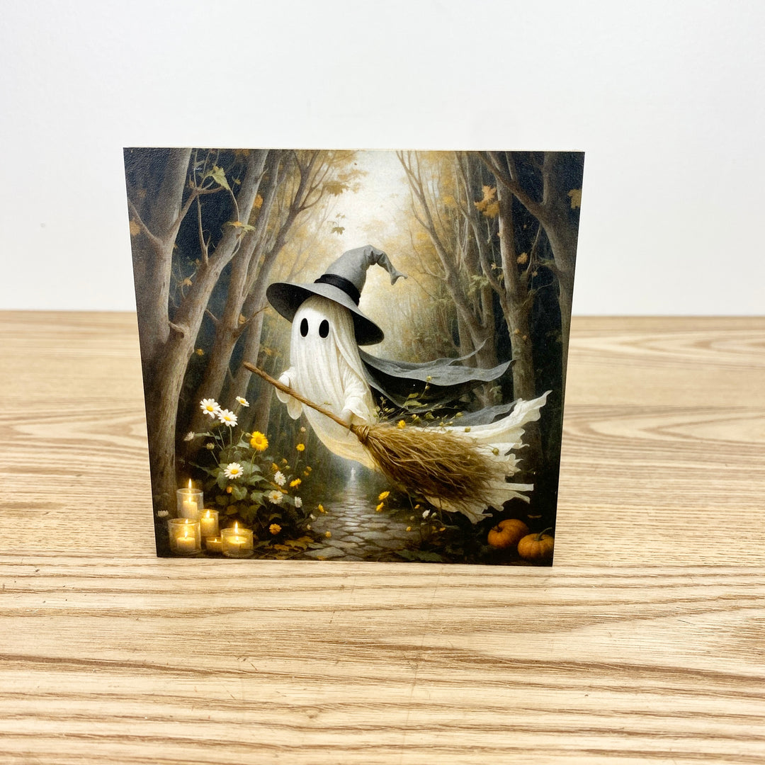 Ghost with a broom in a forest setting on a wooden surface